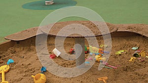 Children`s toys in the sandbox, empty playground