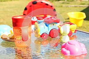 Children`s toys are in the sunlight on the table