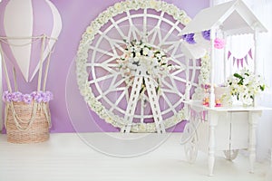 Children`s, wedding, festive photo zone. Trolley with lollipops, cake, cupcakes, balloon with basket, flower arch wheel. Copy