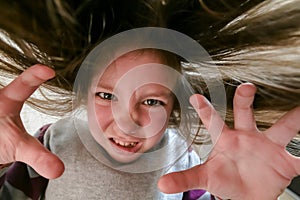 Children`s witchcraft portrait. A small evil girl conjures black magic. A child in the form of a scary zombie photo