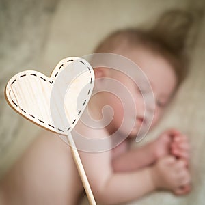 Children`s wooden tablet against the sleeping baby