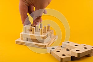 Children`s wooden toy sorter. Educational logic toys for kid`s close-up. Montessori Games for child development blur