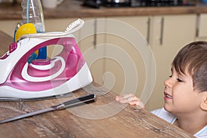 Children safety. Dangerous in the kitchen. Kitchen knife put on table. Selective focus