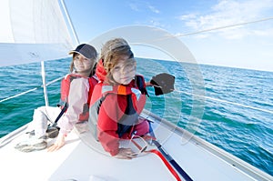 Children sailing on yacht photo