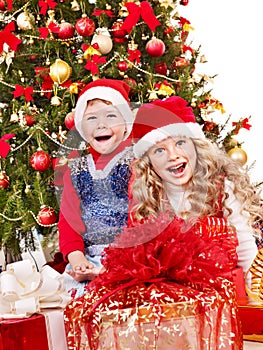 Children in Santa hat with gift box .