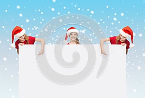 Children in santa helper hats with blank board