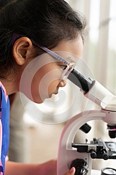Children scientist learning on biology and chemistry in the laboratory. A STEM education learning concept. An Asian student
