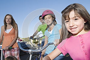 Children With Scooter And Bicycles