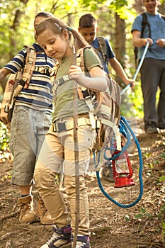 Children scouts and father explore the beautiful forest