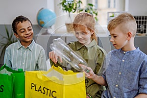 Children separating rubish in to three bins.