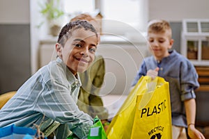 Children separating rubish in to three bins.