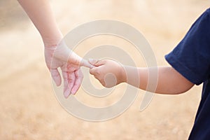 Children shaking hands with blur background,friendship,Girl hold one& x27;s hands walking in road blur background