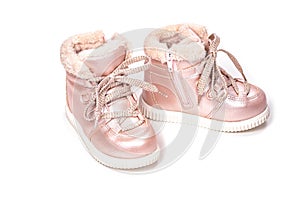Children shoes, pink boots with faux fur for the winter on a white background. Lacing eco-friendly children`s winter shoes