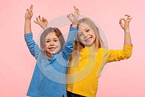 Children showing okay, everything is fine. Two charming happy little girls gesturing ok with fingers and smiling together