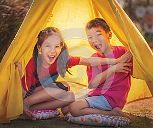Children siblings having a good time in camping coming out with full smile and suprise face for kid healthy lifestyle