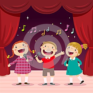 Children sing with a microphone on the stage photo