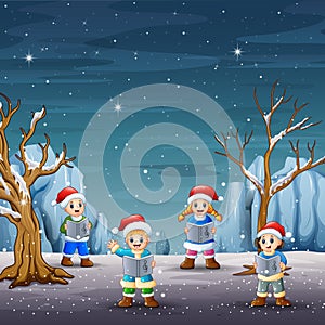 Children singing christmas carols on winter landscape