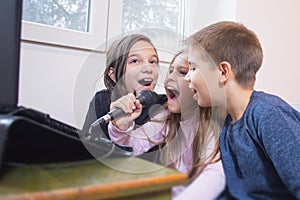 children singing karaoke together