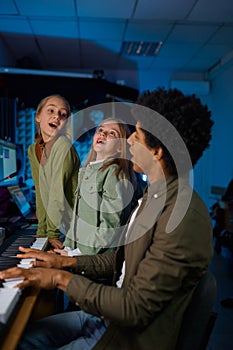 Children singing song to synthesizer accompaniment