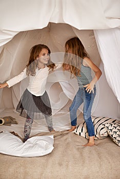 Children, sisters and happy for dancing in bedroom with fort, bonding and connection with care in family home. Girl kids