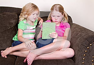 Children or sisters using tablet