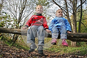 Children sit in park photo