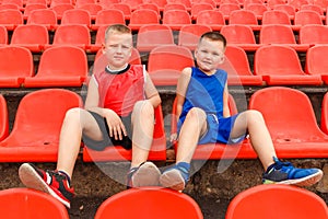 Children sit in sports stands