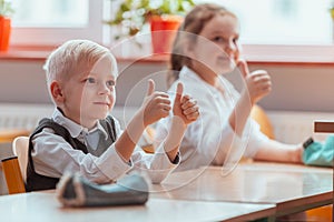 Children sit together at the table during the first physics lesson in the new school year