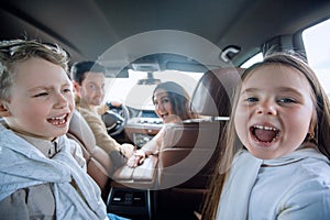 Children sitting in the back seat of the car