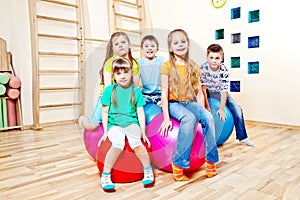 Children sitting on balls