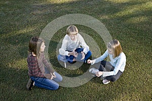Children sitting in a circle on grass talking