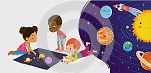 Children sitting on floor explore toy universe, Planets, Stars, Sun, Moon, and Galaxies. Playing and educational