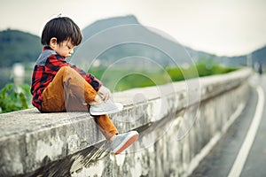 Children sitting on the gound and mountain is back. photo