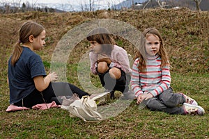 Children sitting on grass in the countryside