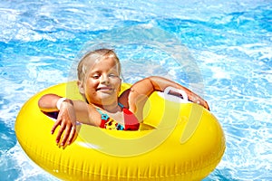 Children sitting on inflatable ring.