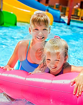 Children sitting on inflatable ring