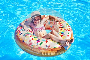Children sitting on inflatable ring in swimming pool. summer. sea
