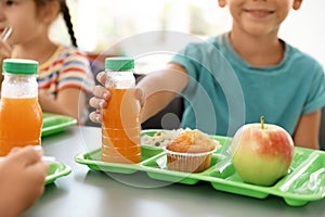 Children sitting at table and eating healthy food