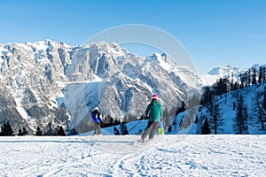 Children skiing at a speed down the slope against the backdrop of the mountains. Concept people, sport.