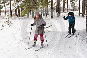 Children skiing on a white snow