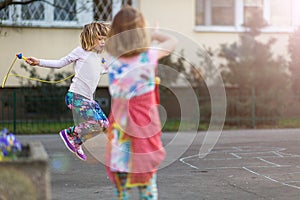 Children skipping outdoors