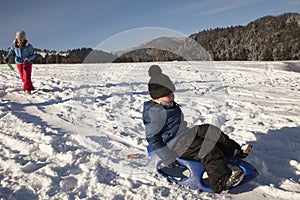 Children sledding On Snow