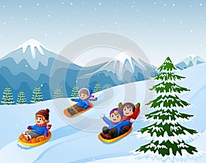 Children sledding snow downhill