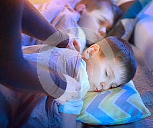 Children sleeping and dreaming in a bed