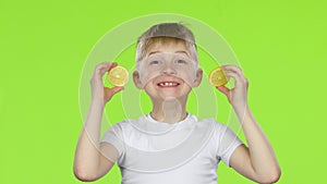 Children with slices of lemon licks them and shows grimaces. Green screen