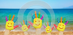 Children smiley hands on a beach