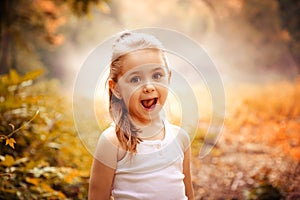 Children Smiling Happiness Concept. Outdoor portrait of a cute smiling little girl.