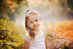 Children Smiling Happiness Concept. Outdoor portrait of a cute smiling little girl.