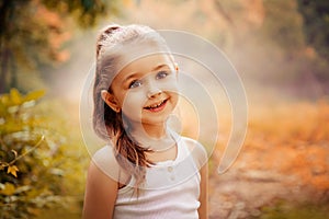 Children Smiling Happiness Concept. Outdoor portrait of a cute smiling little girl.