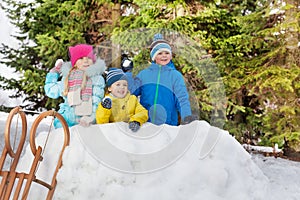 Children in snow fortress play snowball fight